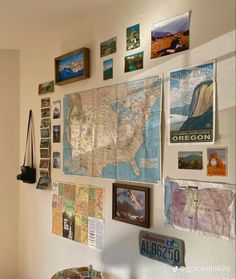 a wall filled with pictures and maps on it