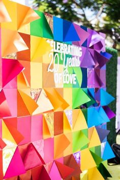 the colorful paper is on display in front of a wall that reads celebrating 20 years of love