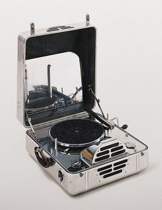 an old fashioned turntable is shown with the lid open to reveal it's inner workings