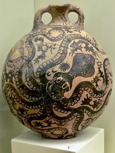 an old vase on display in a museum