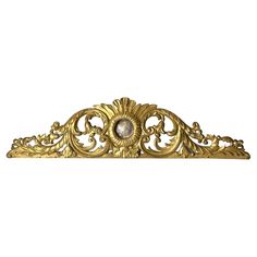 an ornate gold headboard is shown on a white background, with the top part of it