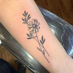 a black and white flower tattoo on the arm