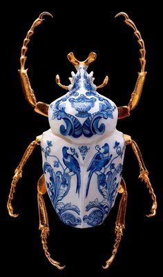 a blue and white vase sitting on top of a black background