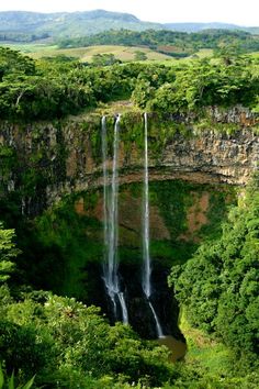 a waterfall in the middle of some trees