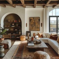 a living room filled with furniture and lots of windows