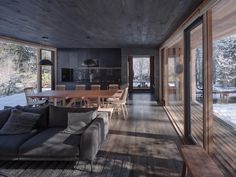 a living room filled with furniture next to a wooden floor covered in lots of windows