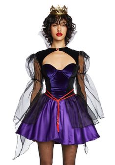 a woman wearing a purple and black dress with mesh sleeves, sheer tulle overlays and a crown on her head