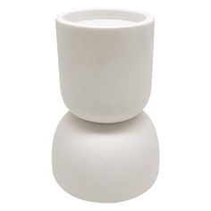 a white vase sitting on top of a table