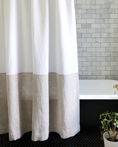 a white bath tub sitting next to a shower curtain