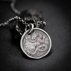 Handmade Sterling Silver 925 Dragon necklace. The silver necklace was oxidized to create more antique rustic look. A dragon necklace often symbolizes power, protection, and a connection to the mystical. It may represent strength, wisdom, and aspirations, reflecting personal qualities such as resilience and leadership. The specific symbolism can vary based on cultural influences and individual interpretations. It is a unisex necklace so it fits both men and women. ❤  Every piece is a unique artwo Sterling Silver Necklace With Dragon Design, Sterling Silver Jewelry With Dragon Design Round Pendant, Symbolic Handmade Coin Necklaces, Silver Dragon Design Round Pendant Jewelry, Silver Jewelry With Dragon Design Round Pendant, Silver Dragon Design Sterling Silver Necklace, Silver Sterling Necklace With Dragon Design, Antique Dragon Design Jewelry For Gift, Antique Dragon Design Jewelry Gift