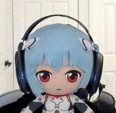 an anime character with headphones on sitting in front of a white door and looking at the camera