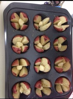 apples are being cooked in a muffin tin