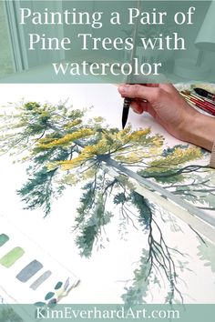 someone painting a pair of pine trees with watercolors on the table in front of them