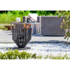 a fire pit sitting in the middle of a garden