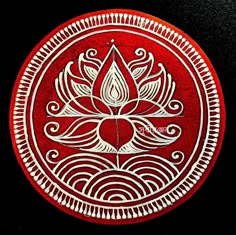 a red and white plate with a flower on it's side, in the middle of a black background