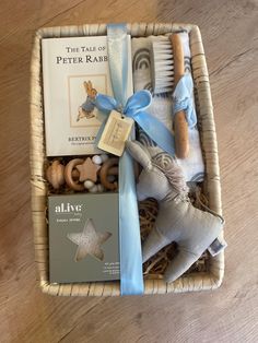 a basket filled with toys and books on top of a wooden floor