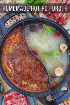 a pot filled with broth and vegetables on top of a table