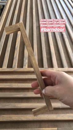 someone is holding some wood planks on top of a wooden table with the words, how to make this door handle out of bamboo?