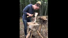 a woman is chopping wood with an ax