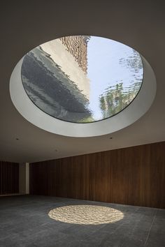 two images show the inside and outside of a building with circular windows on each side