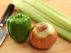 an onion and green pepper on a cutting board