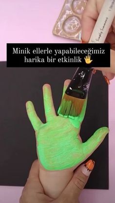 a person holding a paintbrush in their hand that is glowing green and has the words,