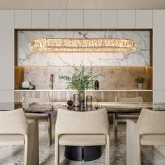 a dining room table with chairs and a chandelier hanging over it's head