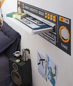 there is a bed and speakers on the wall