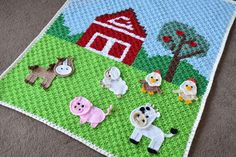 a crocheted blanket with farm animals on it