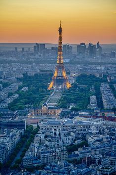 the eiffel tower is lit up at night in paris, france as seen from the top of the eiffel tower