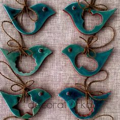 six blue bird ornaments hanging from twine