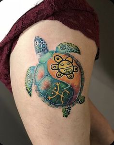 a woman's thigh with a turtle tattoo on it