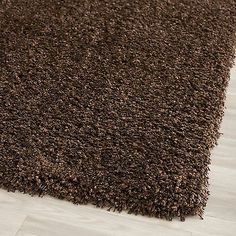 a brown rug on top of a wooden floor