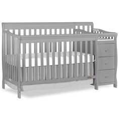 a gray crib with white sheets and drawers on the bottom shelf, in front of a white background