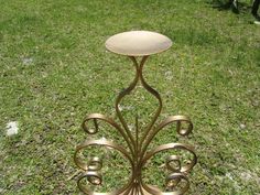 a metal table sitting on top of a lush green field