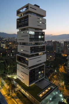 a tall building with lots of balconies on it's sides at night