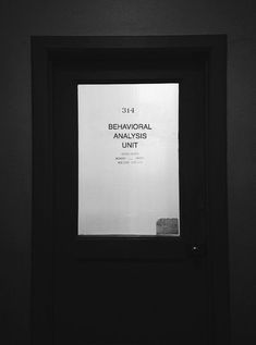 a black and white photo of a door with a sign on it that says behavoial analysis unit