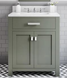 a bathroom vanity with two sinks and a mirror on the wall above it, along with a black and white checkered floor