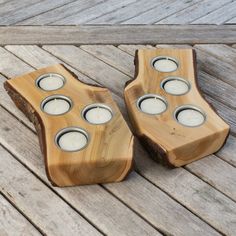 two wooden candles holders sitting on top of a wooden floor