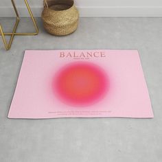 a pink mat with the words balance on it next to a basket and stools