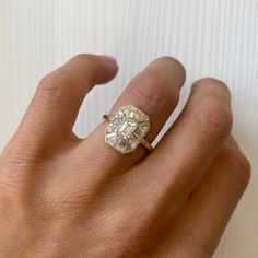 a woman's hand with a diamond ring on it