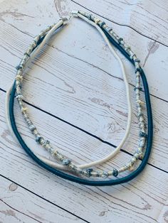 Multistrand statement necklace with 3 layers. Necklaces are made from yarn and thread wrapped rope.   This cream, silver and teal necklace is the perfect color combo for any occasion.  The longest layer is about 27 inches and the shortest roughly 26 inch. Each necklace comes with a 2 inch necklace extender attached.   The necklace is made out of rope wrapped with brown cotton thread, multi-colored neutral silk thread & yarn, and a tan bamboo yarn. This necklace is extremely lightweight.   Dress it up for a girls night out or wear with your favorite T-shirt.   This is a handmade product made by me. Message us if you would like different color options. All necklaces will come with extender attached to adjust length. Layers Necklaces, Neutral Silk, Wrapped Rope, Teal Necklace, Necklace Rope, Bamboo Yarn, Rope Wrapped, Thread & Yarn, Mini Ornaments