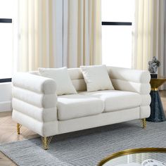 a white couch sitting on top of a wooden floor