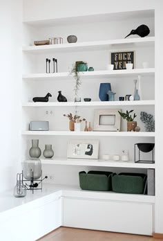 a white shelf filled with vases and other items