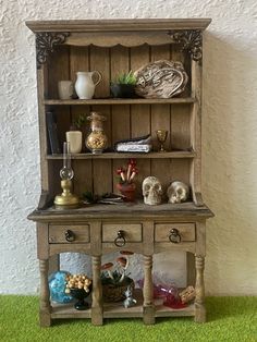 an old fashioned wooden hutch with many items on it's shelf and shelves