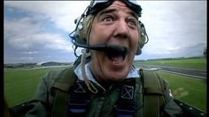 a man with his mouth wide open wearing an airplane helmet