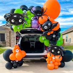 an suv decorated with balloons and decorations for halloween