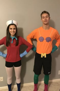 two people in costumes standing next to each other with their hands on their hipss