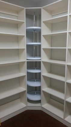 an empty white pantry with shelves in it