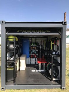 the inside of a storage container with various items in it and equipment stored on top